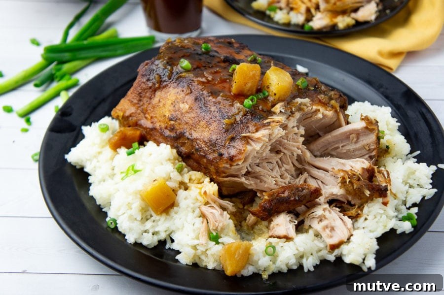 crockpot pineapple pork loin shredded on a platter with rice and sauce