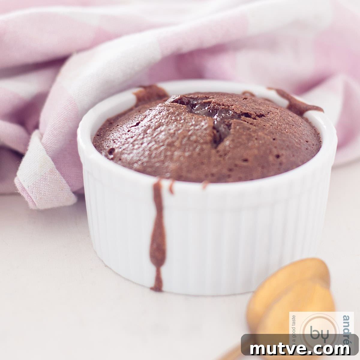 Showstopping Christmas Dessert Recipes 5 A white jar with molten chocolate in it. A pink white cloth in the background