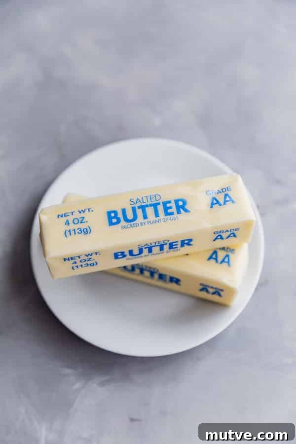 An overhead shot of two sticks of butter on a plate from how to soften butter