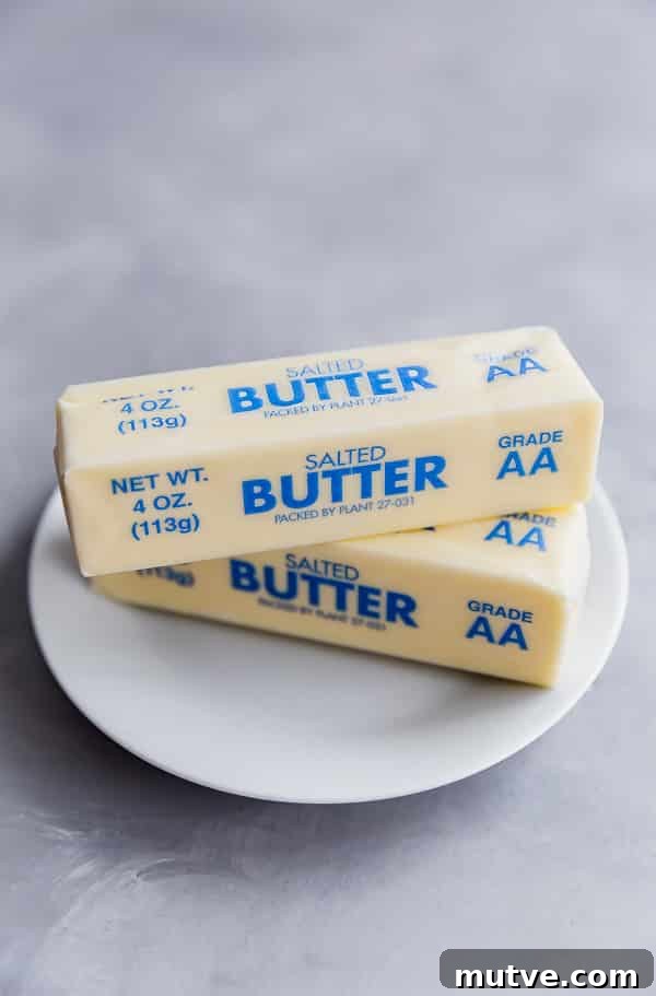 Two sticks of butter on a plate from how to soften butter
