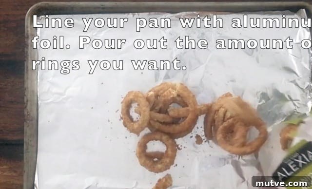Crispy Frozen Onion Rings: Oven, Air Fryer and Skillet 3 Frozen onion rings on a baking sheet lined with aluminum foil