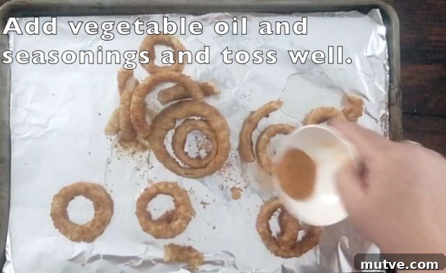 Crispy Frozen Onion Rings: Oven, Air Fryer and Skillet 5 Small white bowl pouring out seasonings onto the baking sheet