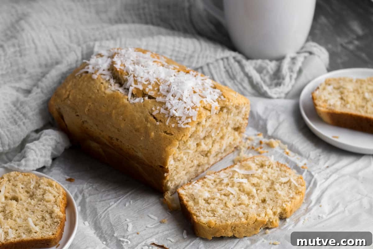 One-Bowl Coconut Bread: Moist Homemade Loaf 2 coconut bread with a slice of bread on a plate