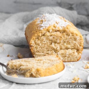 One-Bowl Coconut Bread: Moist Homemade Loaf 6 coconut bread with a slice on a plate